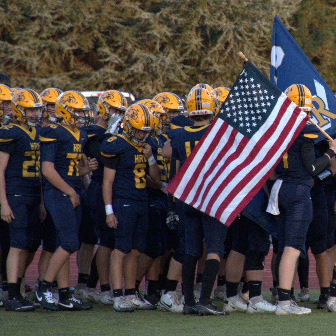 The Hood River Valley football team runs out before a game earlier this year     Zach Thummel photo